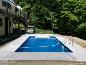 Swimming Pool Next To A Forest And A House